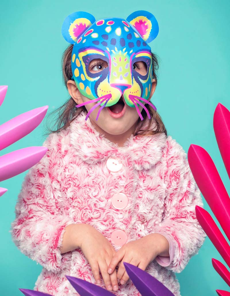 Girl in a colorful paper jaguar mask