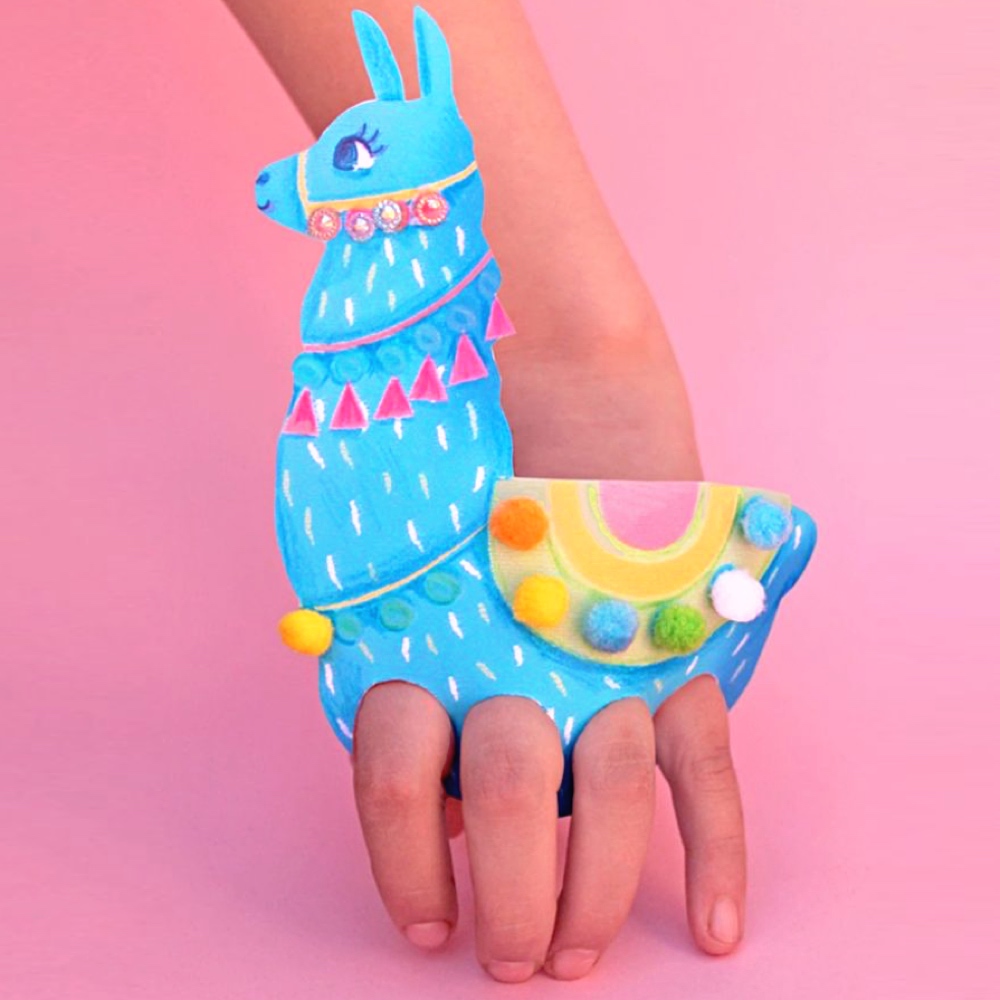 human fingers in a paper llama puppet